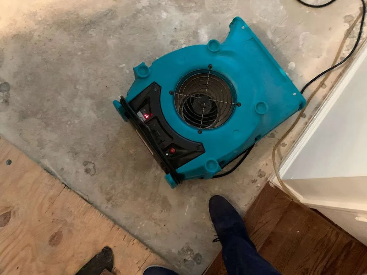 Air mover drying subfloor during Leak Detection & Repair in Brookings